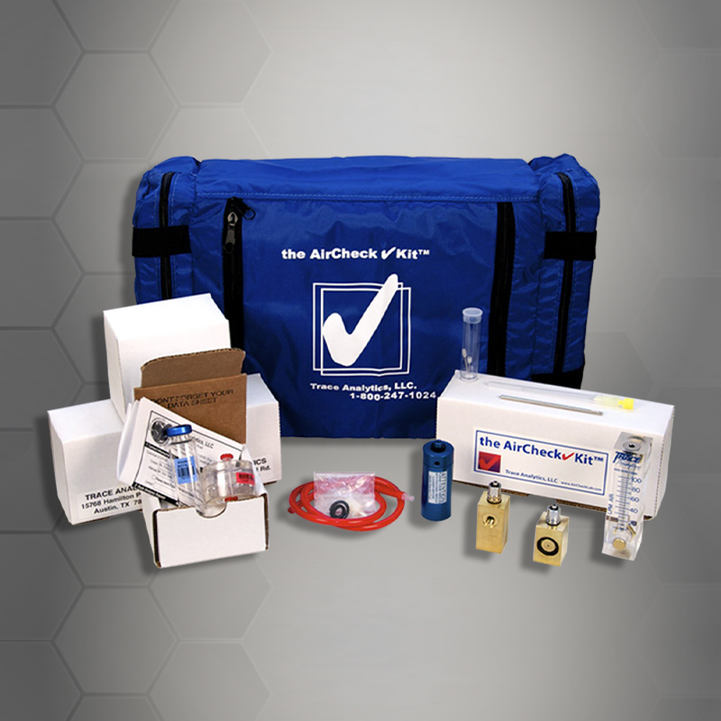 A display of an air quality testing kit, which includes various sampling equipment, testing tubes, and a blue carrying case with a company logo labeled 'the Air Centers of Florida aircheck kit™
