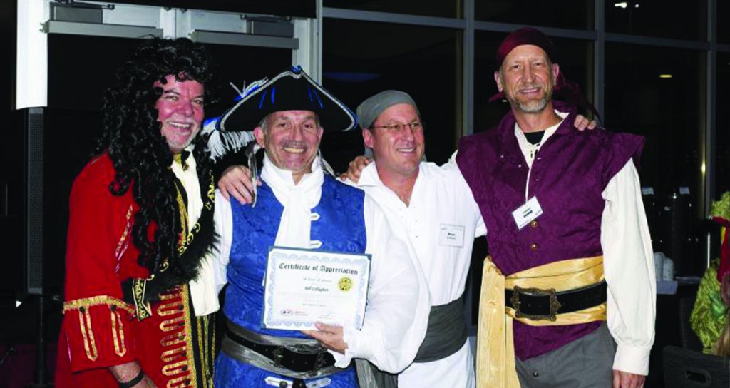 Four individuals dressed in costume at an Air Centers of Florida event, one holding a certificate of appreciation, sharing a cheerful moment together.